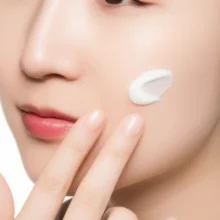 A-close-up-of-hands-applying-anti-aging-cream-to-the-nasolabial-fold-area.