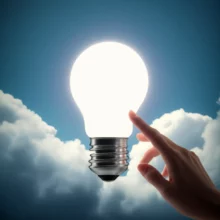 A-glowing-lightbulb-representing-a-secret-signal-of-hope,-surrounded-by-comforting-clouds.