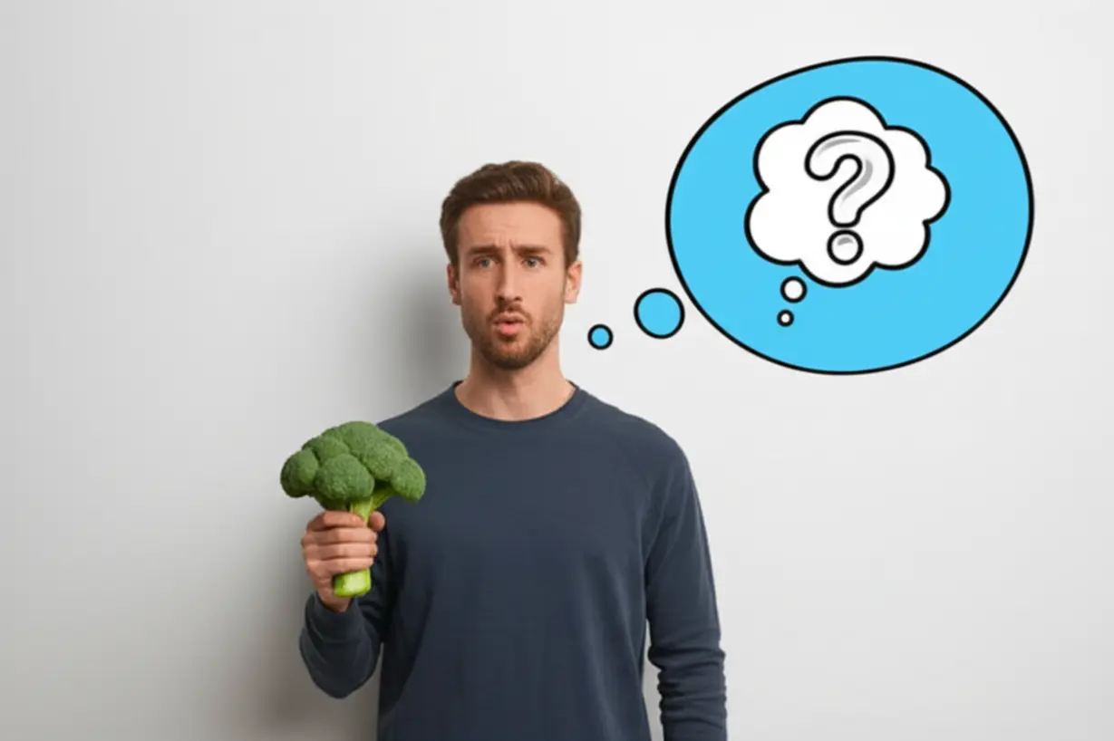 브로콜리를-들고-놀란-표정을-짓는-사람의-귀여운-3D-이미지.-생각-풍선에는-물음표와-작은-가스-구름-아이콘이-있다.
