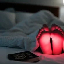 밤에-발바닥이-뜨거워-걱정하는-모습의-귀여운-3D-캐릭터가-이불-속에-앉아있는-이미지